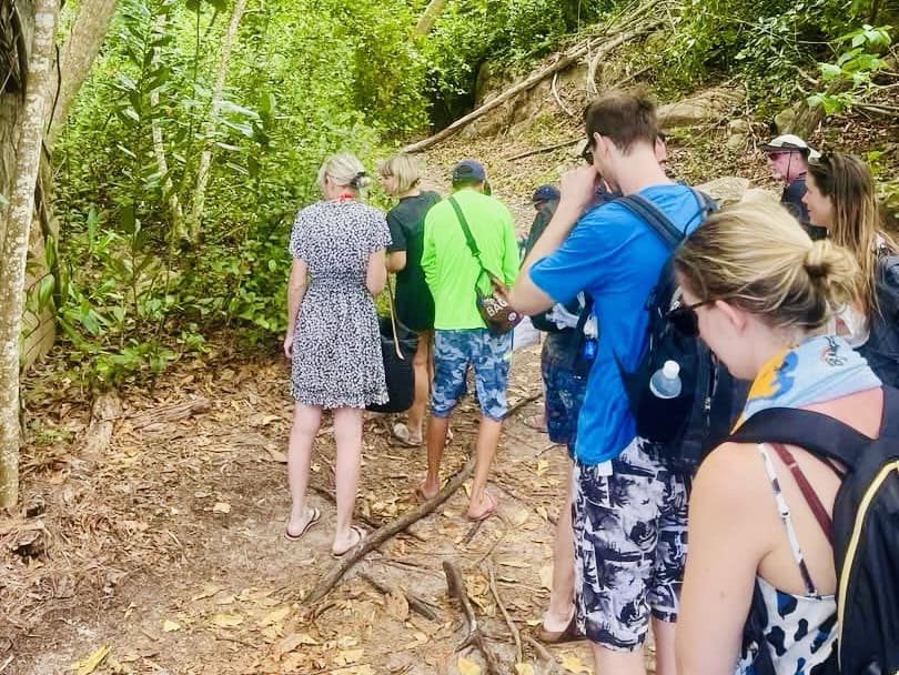 Tourists hiking in tropical forest Seychelles